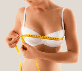 The girl measures the bust with an inch